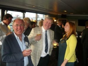 Peter G. Owen of Isis Communications and president of the Seahorse Club flanked by fellow journalsits
