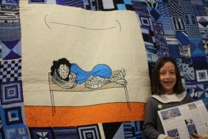 Young supporter Ada admires Black Tears tapestry.
