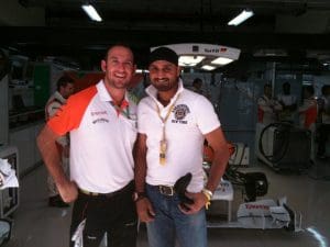 James Barr showing Indian cricketer Harbhajan Singh around the Sahara Force India garage at the Buddh International Circuit, India.