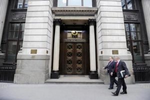 Men walk past the London Metal Exchange (LME) in London, July 22, 2011.REUTERS/PAUL HACKETT