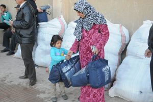 Displaced Syrians receive UNICEF winter clothing kits. Photo: UNICEF/Aho Yousef