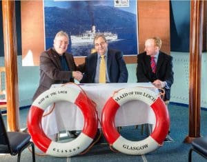 Iain Robertson (LLSC), Neil Patterson (OSD), and Mike Cantlay OBE (VisitScotland), signing the contract on board Maid of the Loch [Paul Saunders Photography]