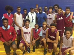 NBA icon Earl Monroe (centre, in blue) with the CedarBridge high-school basketball team andHead Coach Rickey Watts